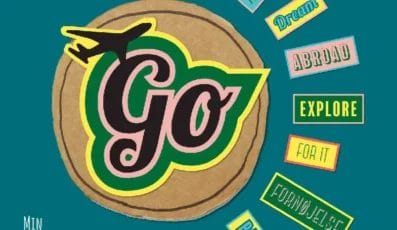 A colorful cover with a plane and Go in bold letters at the center. Surrounding words include Rejse, Explore, Dream, Abroad, and more. Danish text at the bottom reads: Min ultimative guidebog før, under og efter vores ophold i udlandet.